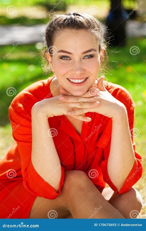 Young Beautiful Brunette Woman In Red Dress In Autumn Park Stock Image