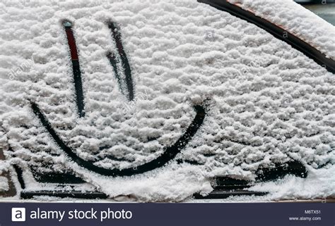 Snow Background Texture Of Wet Snow With A Cheerful Smiley Symbol