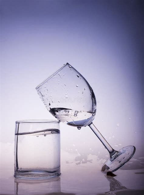 glasses filled with water water pours into a glass with splashes stock image image of bottle