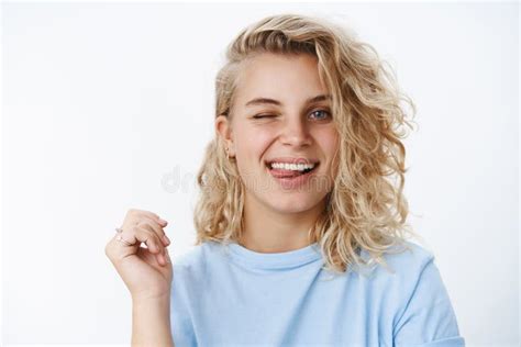 Girl In Flirty And Happy Mood Winking And Sticking Out Tongue Playfully
