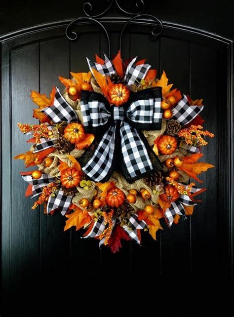 A Wreath With Pumpkins Leaves And Other Autumn Decorations Hanging On