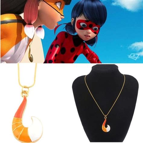 Two Necklaces On Display Next To A Mannequin With An Image Of Lady Bug