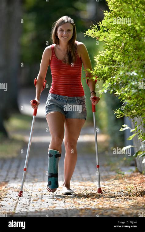 Young Woman With A Foot Injury And Plaster On Crutches Germany Stock