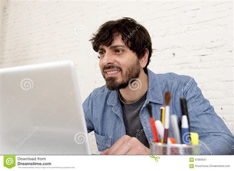 Corporate Portrait Of Young Hispanic Hipster Businessman Working At