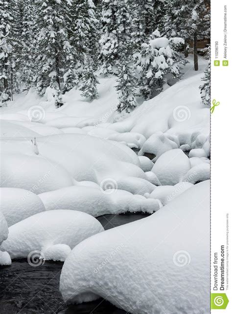 Powder Snowdrifts On The Stones Of Mountain River And Forest Snowfall