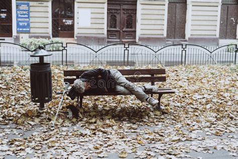 Homeless Sleeping On The Benches In The Autumn Park Editorial Stock