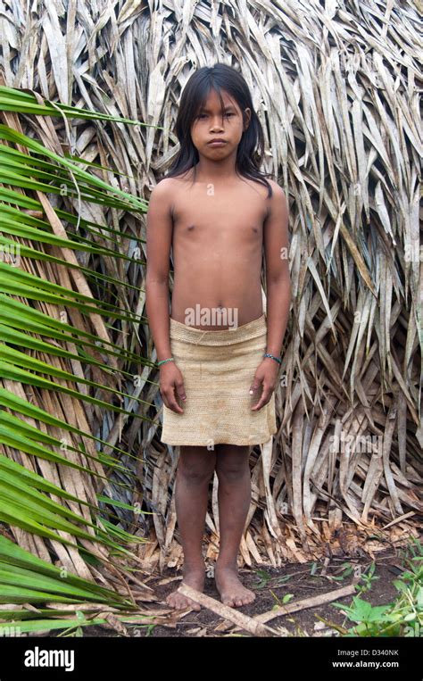 Un joven mayorunas matses delante de una maloca casa tradicional amazónicos perú Fotografía