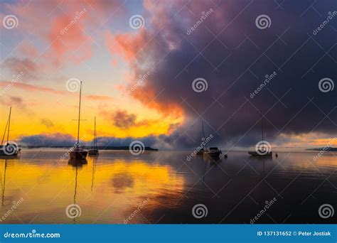 Sunrise On The Lake With Boats Reflection Of Sun In Water With Fog