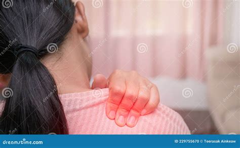 Close Up Of Female Massaging Her Painful Shoulder Caused By Prolonged Work On The Computer Or