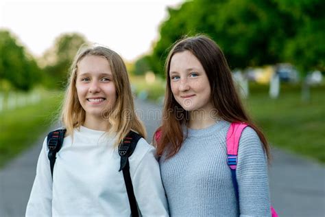 Two Girls Schoolgirl Teenager In Summer After School In Nature To Pose On Camera Emotions Of