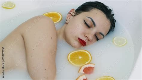 Sexy Naked Woman Bathing In Milk Bath Filled With Fruit Relax Spa And Skin Care Concept V Deo