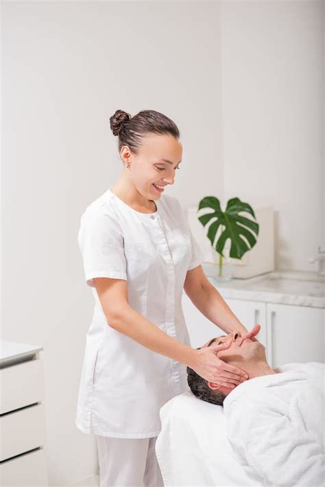 Happy Female Beautician Doing Facial Massage Stock Photo Image Of