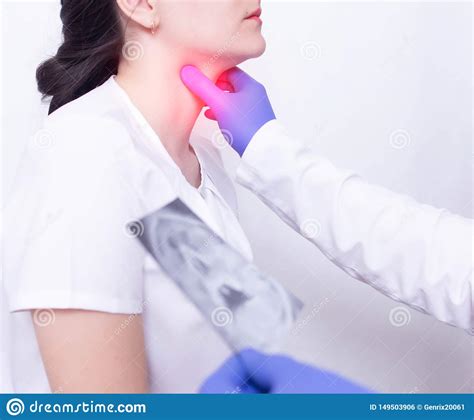 A Specialist Doctor Diagnoses A Girl S Sore Throat By Palpating For The
