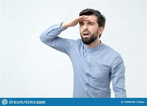 Confused Young Hispanic Man With Beard Looking Far Away Stock Photo