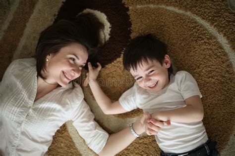 beautiful brunette mom playi and hugging with son picture image 122788011