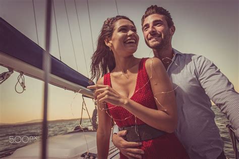 Happy Couple Taking A Romantic Cruise On The Sail Boat Happy Couple Taking A Romantic Cruise