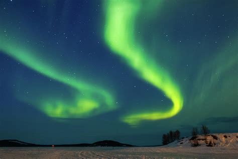 Double Aurora Above Frozen Lake Inari Finland Photograph