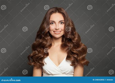 Portrait Of Cheerful Woman With Long Curly Beautiful Hair Smiling Stock