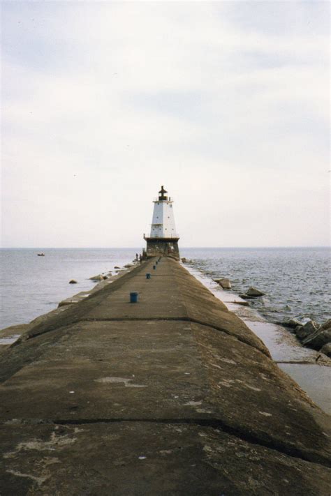 Pier fishing for whitefish slowed with only a few caught in the early morning. Ludington, MI - Pier and lighthouse on Lake Michigan ...