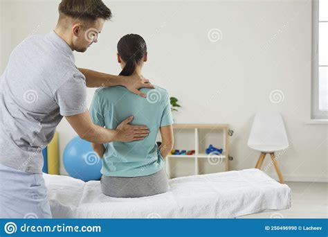 Osteopathic Medicine And Physiotherapy Osteopath Examining Womanand X27s Back In In Modern