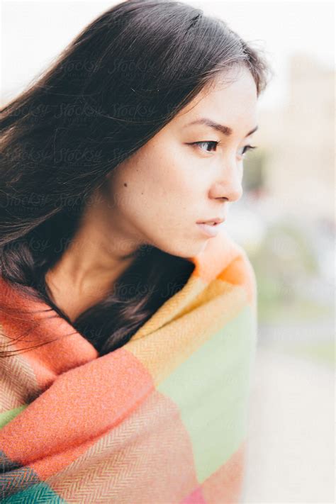 Beautiful Woman Wrapped In Colored Blanket Looking At Right By Stocksy Contributor Andrey