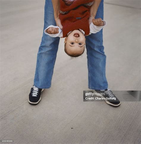 Woman Holding Baby Upside Down High Res Stock Photo Getty Images