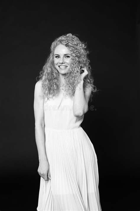 Portrait Of A Pretty Curly Blonde Woman Wearing Light Dress Stock