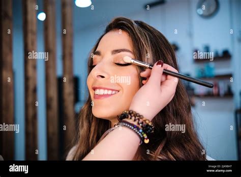 Woman Smiling While Getting Her Makeup Done In The Beauty Salon Stock