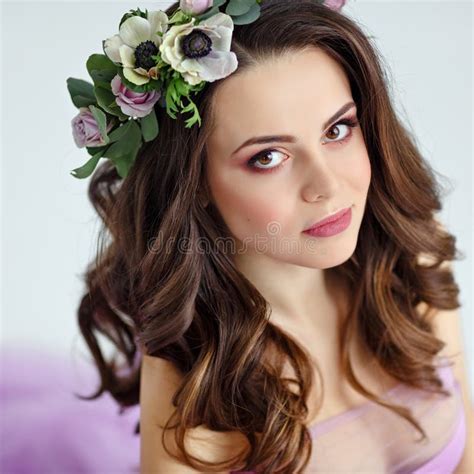 Portrait Of Sensual Beautiful Brunette Girl In Purple Dress Wreath And Bouquet Of Flowers