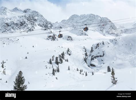 Gondolas Of Cableway At Stubai Glacier Ski Resort With Snowy Mountains