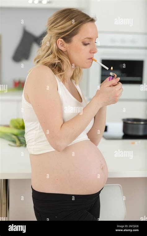 Pregnant Woman Smoking Cigarette At Home Stock Photo Alamy