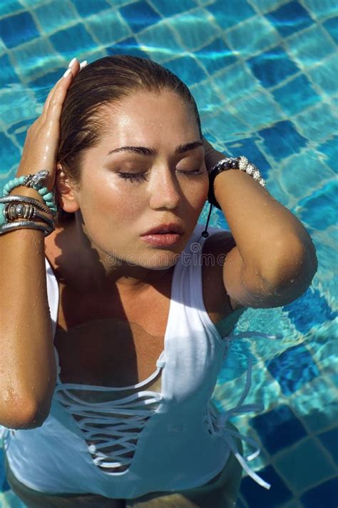 Woman In White Swimsuit Posing Near Swimming Pool Beautiful Stylish Tan Girl Summer Day On