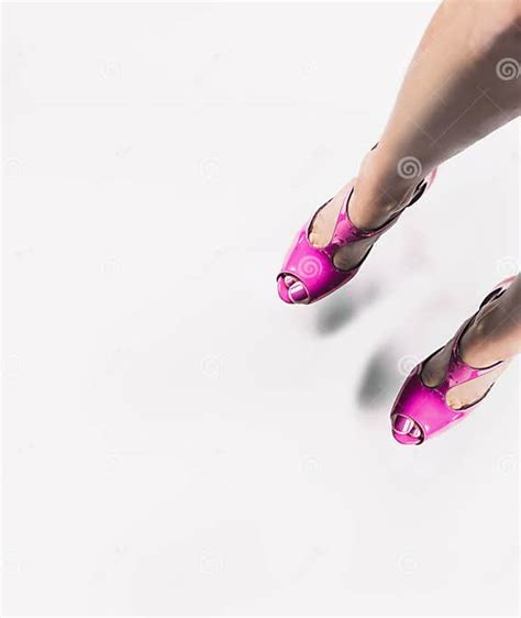 Female Legs In Bright Pink Pumps Hanging Over White Floor Background Top View Beautiful Legs