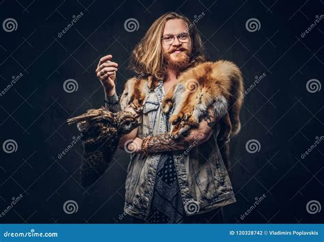Portrait Of A Tattoed Redhead Hipster Male With Long Luxuriant Hair And