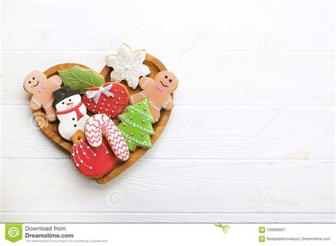 So we like to make christmas cookies. Various Types Of Christmas Decorative Gingerbread Cookies On Wooden Heart Shaped Plate On White ...