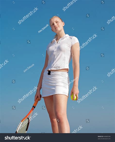 Young Blond Tennis Player With Tennis Racket And Tennis Balls In White
