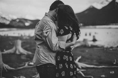 Adventurous Engaged Couple Hugging In Beautiful Mountain Landscape In