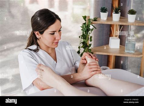 Female Therapist Massaging Foot Of Patient In Clinic Stock Photo Alamy