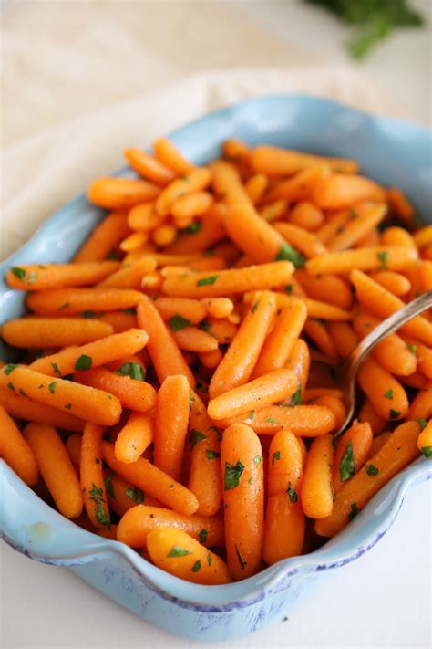 These glazed carrots are carrot slices that have been sautéed in butter and sugar, then cooked in stock until sauce is reduced to a glaze. Honey-Glazed Baby Carrots - The Comfort of Cooking