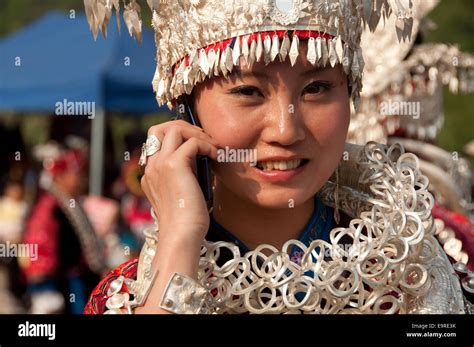 a-miao-girl-with-traditional-wear-and-silver-jewels-talking-at-her