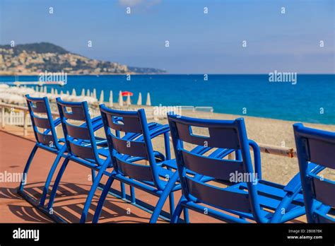 Mediterranean Sea And Famous Blue Chais On Promenade Des Anglais At