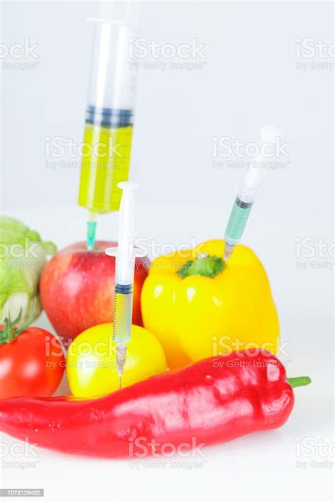 Three Syringes In Fruits And Vegetables Genetically Modified Food
