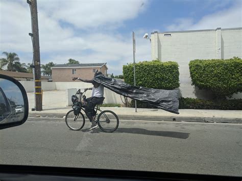 There are various types of garbage bags in south korea. PsBattle: Man on a bicycle with a garbage bag cape ...