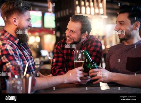 Three Smiling Men Drinking Beer In The Pub Stock Photo Alamy