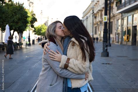 newly married lesbian couple on a honeymoon in a city the women are showing their love in