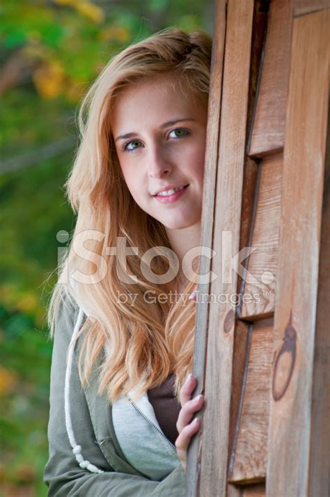 Teenage Girl Hiding Behind The Shed - I Stock Photo | Royalty-Free ...