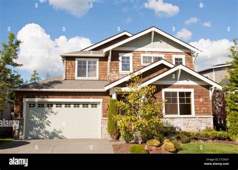 New Beautiful Suburban House With Blue Sky And Clouds Stock Photo