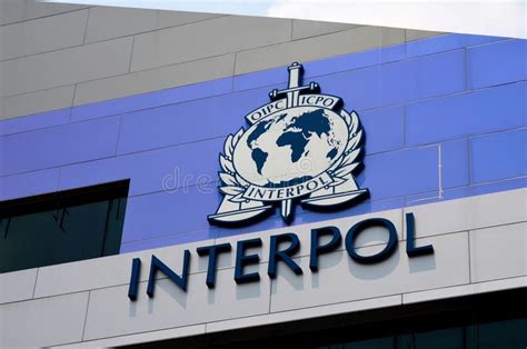 Connecting 194 member countries for a safer world. International Police INTERPOL Sign And Logo On Building ...