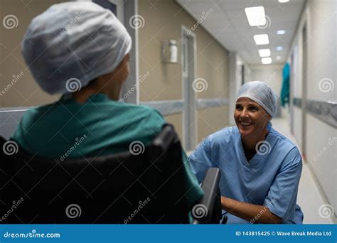 Female Surgeon Talking With Female Patient In The Hospital Corridor