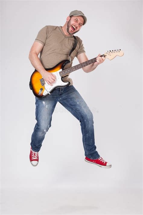Man Play On Electric Guitar And Jumping In The Air Stock Image Image